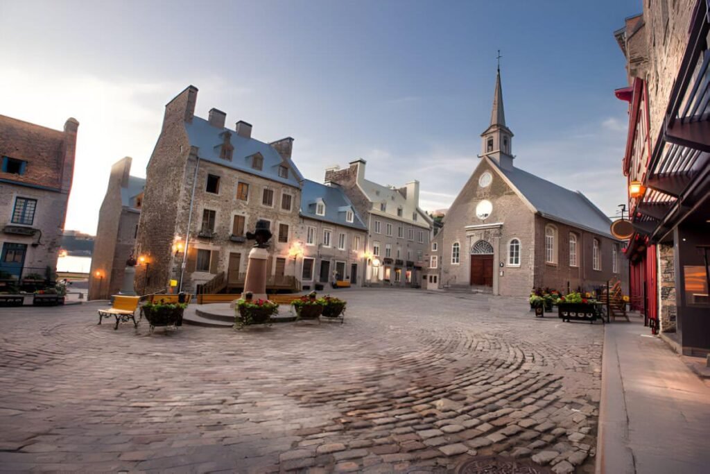 A picturesque view of Old Quebec, showing the historic fortified walls and the iconic Château Frontenac overlooking charming cobblestone streets.