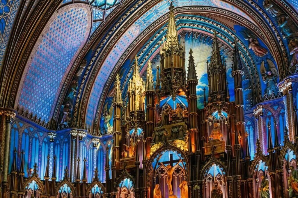 The majestic interior of Notre-Dame Basilica in Montreal, highlighting its ornate Gothic Revival architecture and colorful stained glass windows.