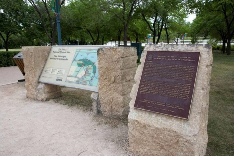 The Forks National Historic Site with the confluence of the Red and Assiniboine Rivers, bustling shops, restaurants, and a market.