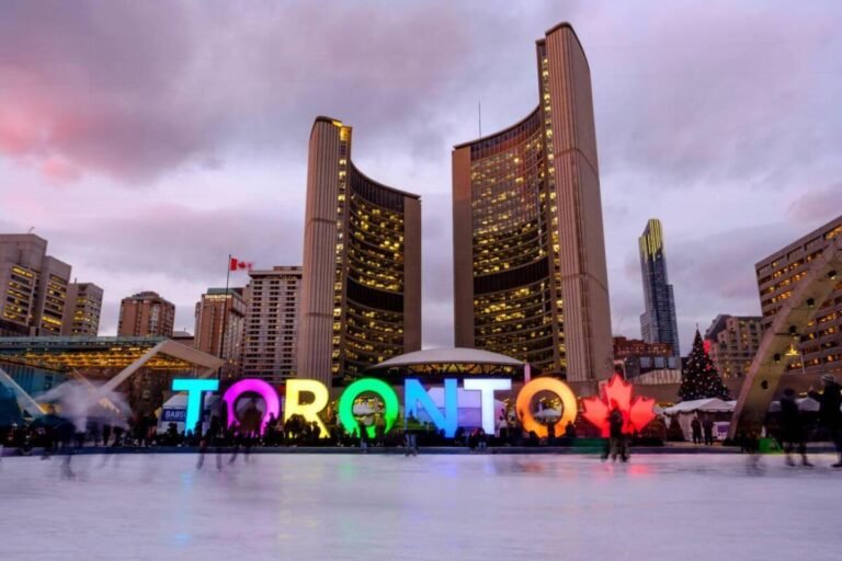 Winter scene in Toronto with people ice skating, snow-covered streets, and festive lights.