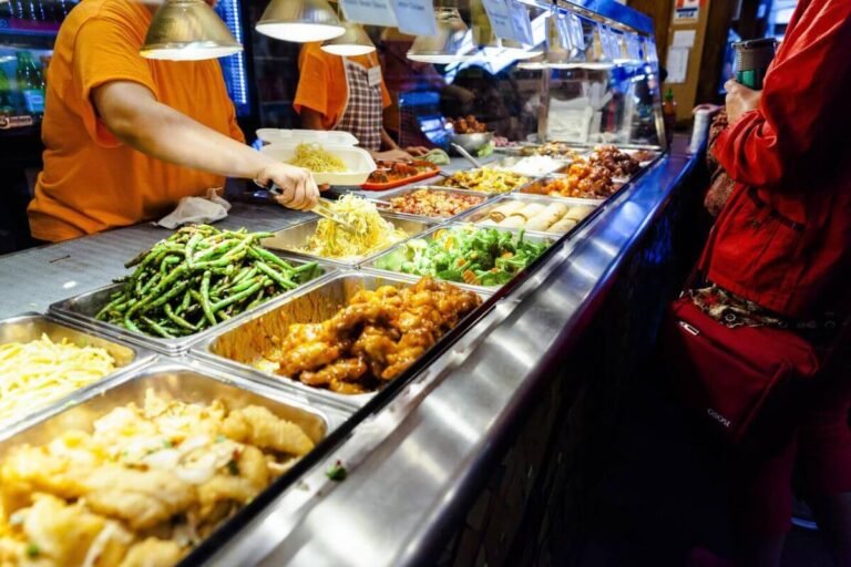 A bustling street food market in Vancouver with various food trucks and stalls